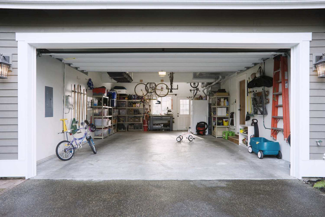 Well-organized motorcycle garage with essential items like garage mat, helmet holder, and repair tools for motorcycle maintenance