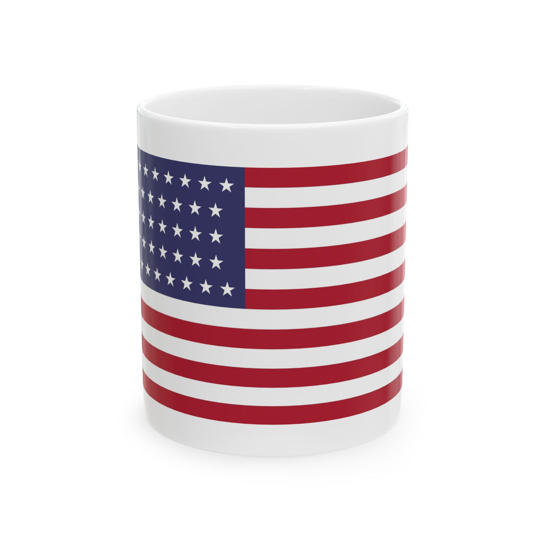 The U.S Flag Motorcycle Pit Mat Mug by Motorcycle Pit Mat features a white mug with red and white horizontal stripes and a blue square of white stars—an ideal accessory for your motorcycle garage mat.