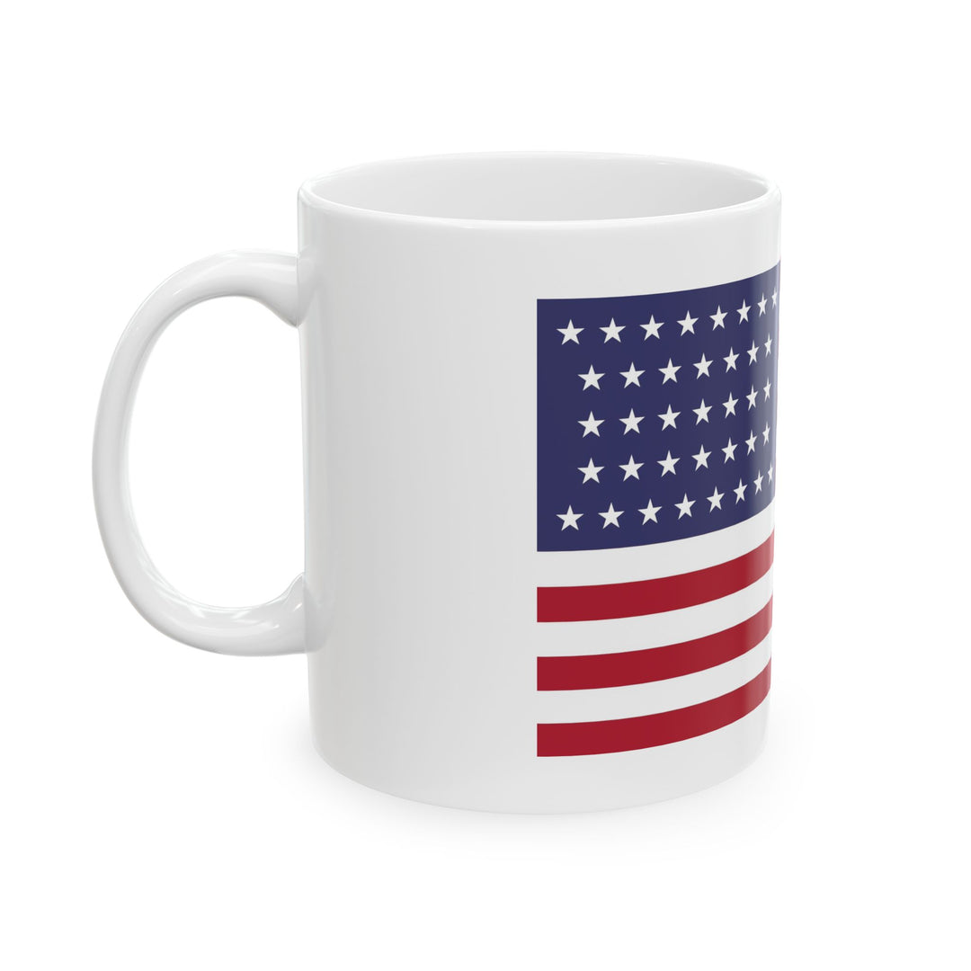 The U.S. Flag Motorcycle Pit Mat Mug by Motorcycle Pit Mat features a design with red and white stripes and white stars on a blue background, perfect for sipping coffee in your motorcycle garages cozy corner.