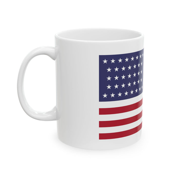 The U.S. Flag Motorcycle Pit Mat Mug by Motorcycle Pit Mat features a design with red and white stripes and white stars on a blue background, perfect for sipping coffee in your motorcycle garages cozy corner.