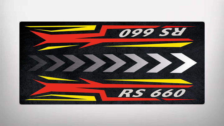 The Motorcycle Pit Mat for RS660 features a bold RS 660 design, with red and yellow angular shapes and gray arrows conveying speed. These elements mirror horizontally against a dark background, enhancing its dynamic look.