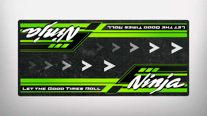 The Motorcycle Pit Mat for Kawasaki Ninja features a green and black striped rectangular decal with right-pointing arrows. Ninja appears in white, along with the slogan Let the Good Times Roll at the bottom in white text on a green background—ideal for any motorcycle enthusiast.