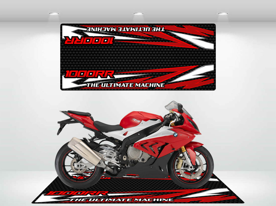 A sleek red and white sport motorcycle is showcased in a showroom on a Motorcycle Pit Mat for the S1000RR, enhancing its allure against graphic designs that feature 1000RR and THE ULTIMATE MACHINE in bold, stylized letters.