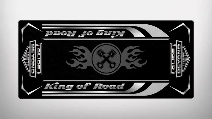 The sleek black and silver Motorcycle Pit Mat for King of Road features King of Road on the top and bottom. Crossed spanners with flame motifs spotlight durability, while bold rectangular borders display GLIDE BEYOND and BEYOND LIMITS on the sides.