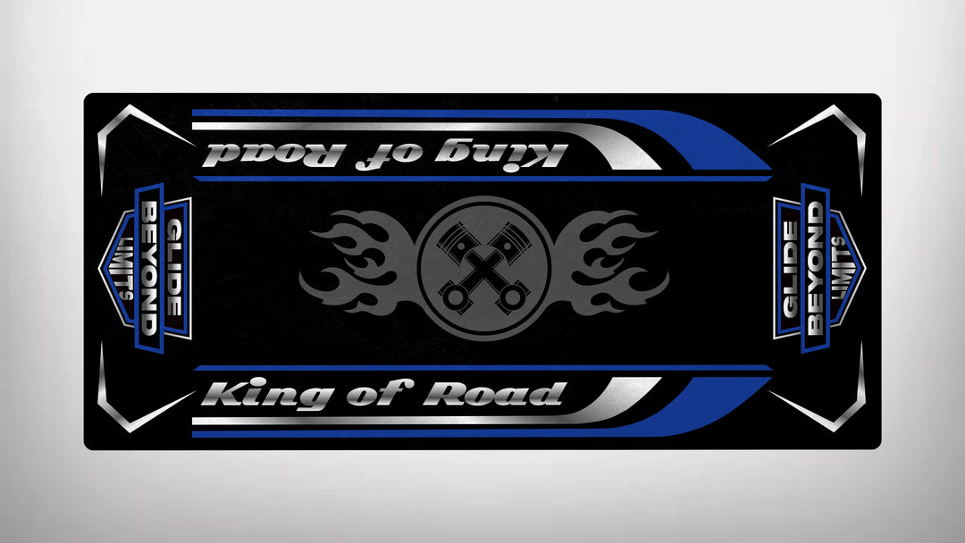 This Motorcycle Pit Mat, Motorcycle Mat for King of Road, features a black and blue design with stylized King of Road text, silver stripes, flaming wrench symbols, and the phrase Glide Beyond Limits. Its sleek, symmetrical design exudes durability with a metallic appearance.